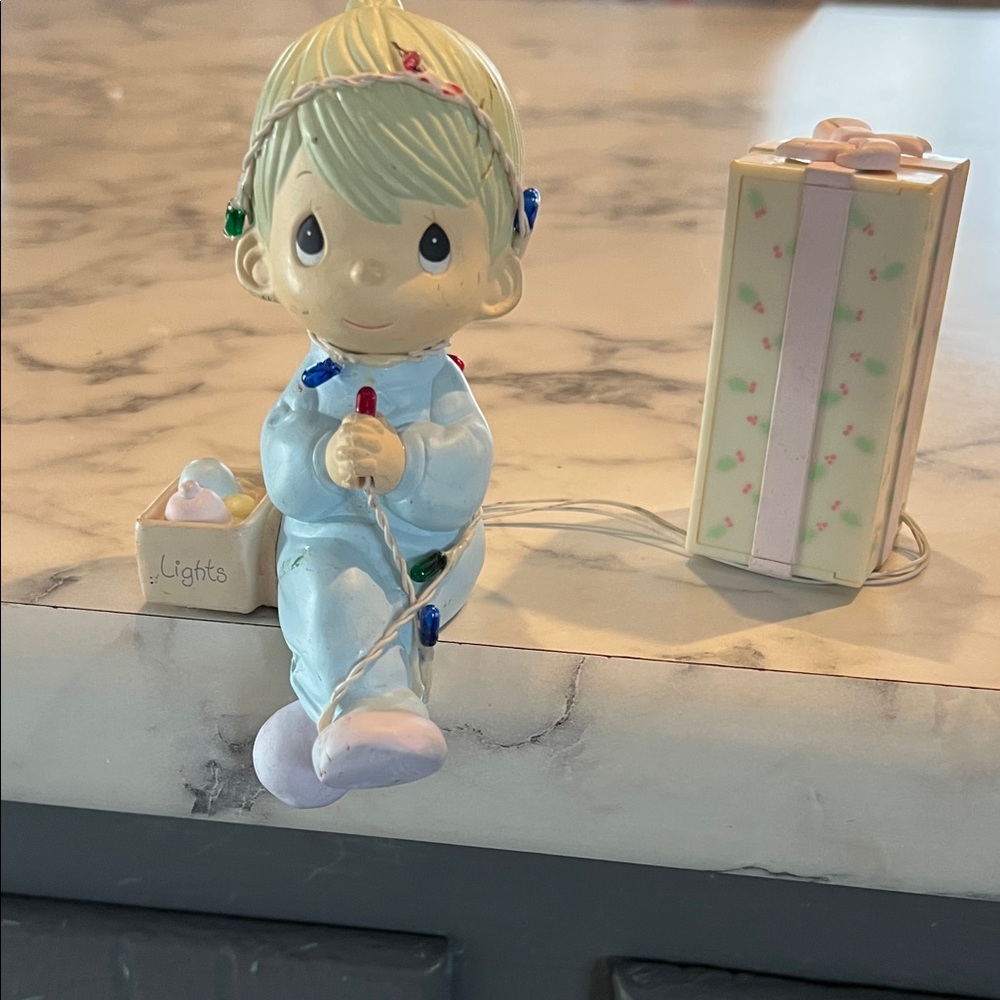 Precious Moment Figurine lights up with present and Christmas Lights